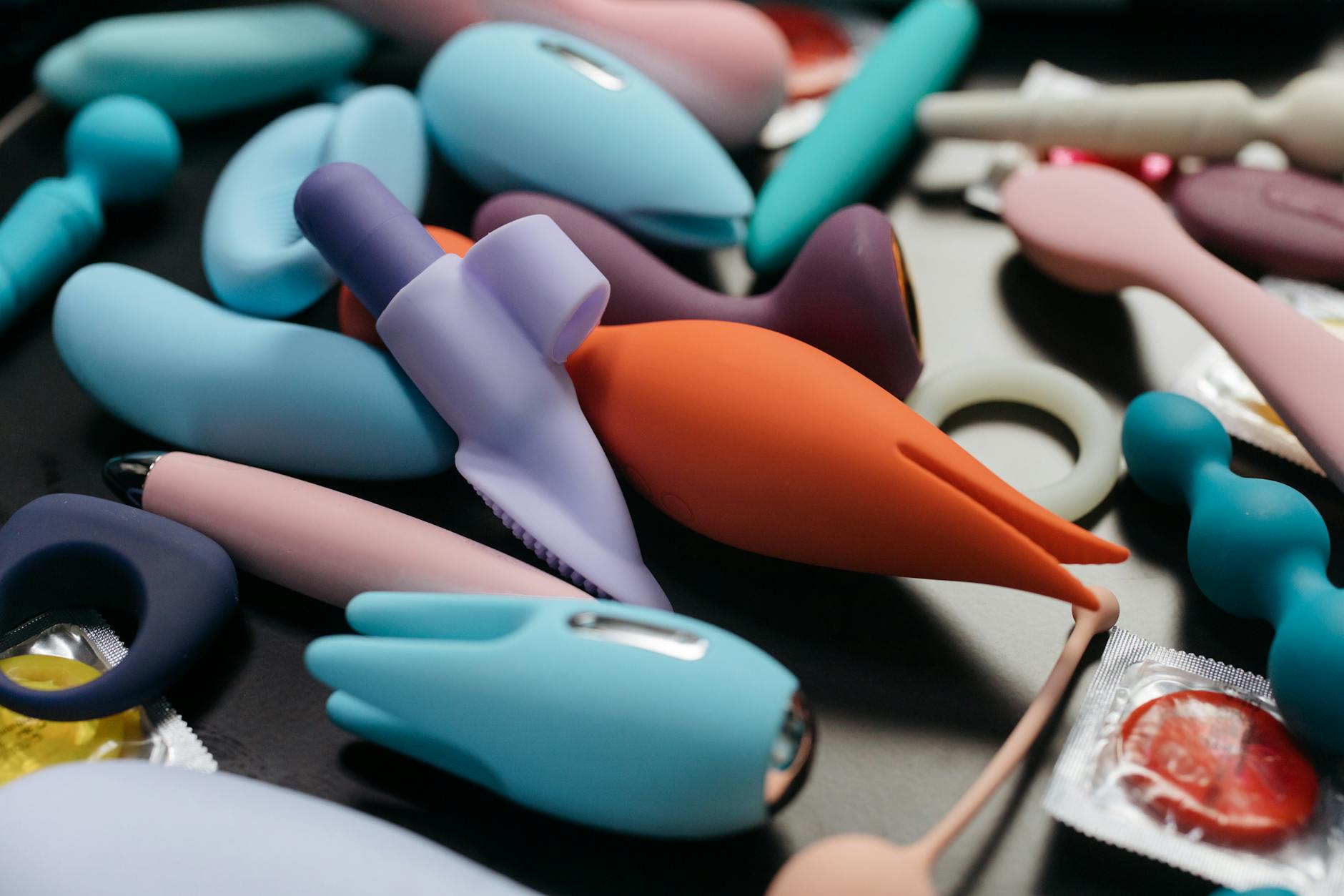 An array of vibrant clitoral vibrators including lemon and wand styles in close-up